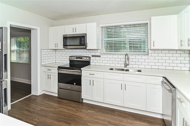 kitchen featuring sink, dark hardwood / wood-style floors, white cabinets, and appliances with stainless steel finishes