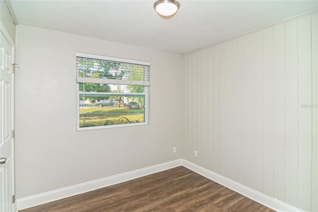 empty room with dark hardwood / wood-style flooring