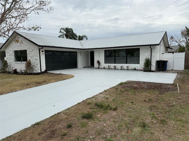 single story home featuring a front yard and a garage