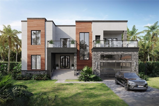 modern home with a balcony, a front yard, and a garage