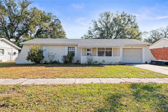 ranch-style house with a garage and a front lawn