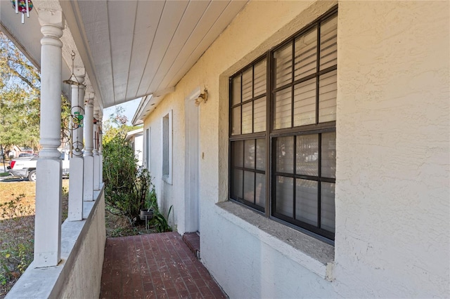 view of side of home with a porch