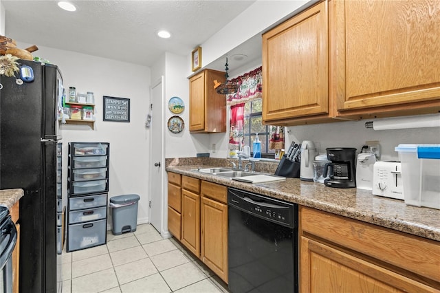 kitchen with dark stone countertops, black appliances, a textured ceiling, sink, and light tile patterned flooring