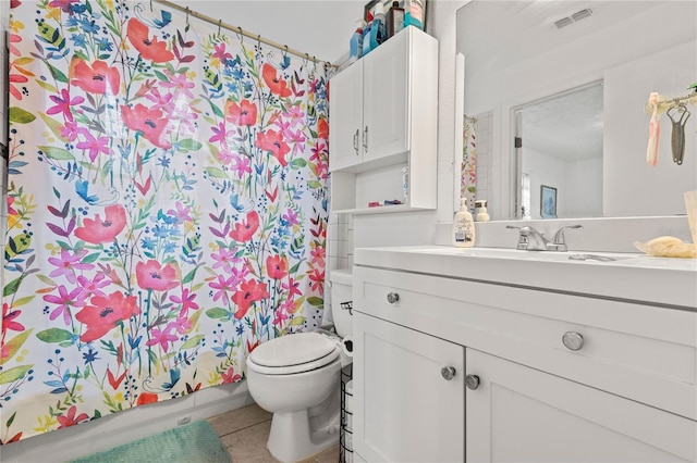 bathroom featuring toilet, a textured ceiling, tile patterned floors, and vanity