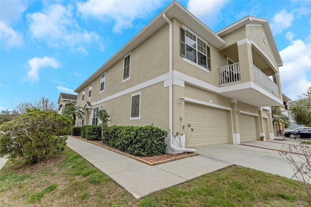 view of side of home with a balcony and a garage