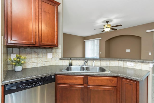 kitchen with kitchen peninsula, ceiling fan, backsplash, stainless steel dishwasher, and sink