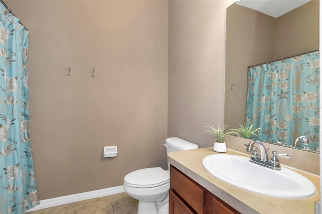 bathroom featuring toilet, vanity, and tile patterned flooring