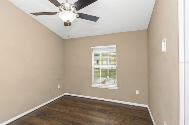 spare room featuring dark wood-type flooring and ceiling fan