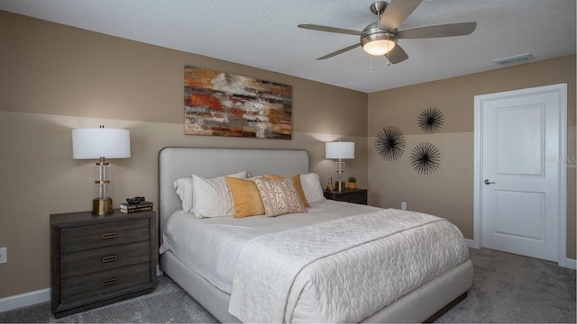 carpeted bedroom with a textured ceiling and ceiling fan