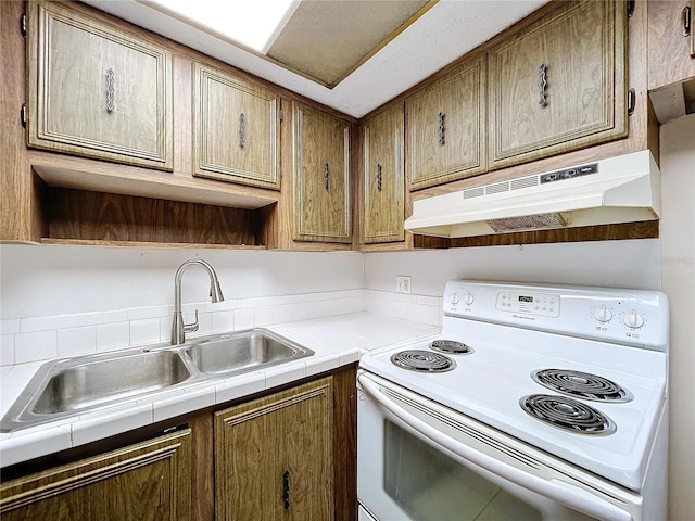 kitchen with sink, white range with electric stovetop, and tile countertops