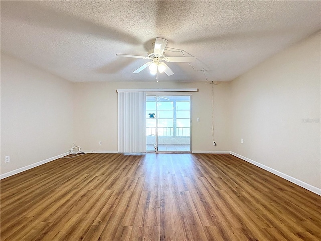 spare room with ceiling fan, a textured ceiling, and wood-type flooring