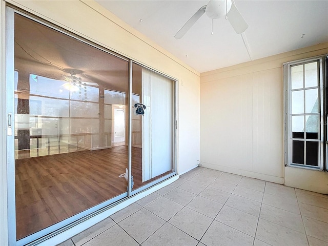 unfurnished sunroom featuring ceiling fan and a healthy amount of sunlight