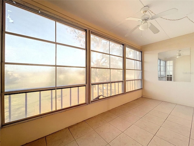 unfurnished sunroom featuring ceiling fan