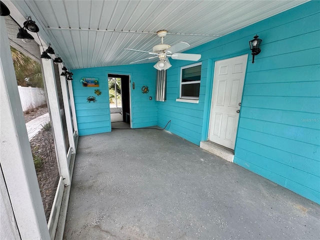 unfurnished sunroom featuring ceiling fan and lofted ceiling