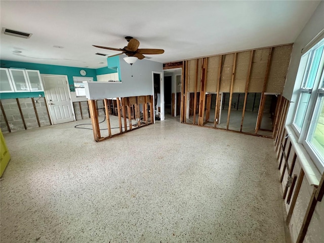 interior space with ceiling fan and plenty of natural light