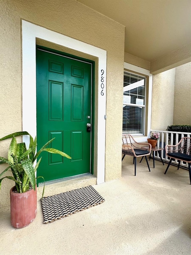 view of exterior entry with a porch