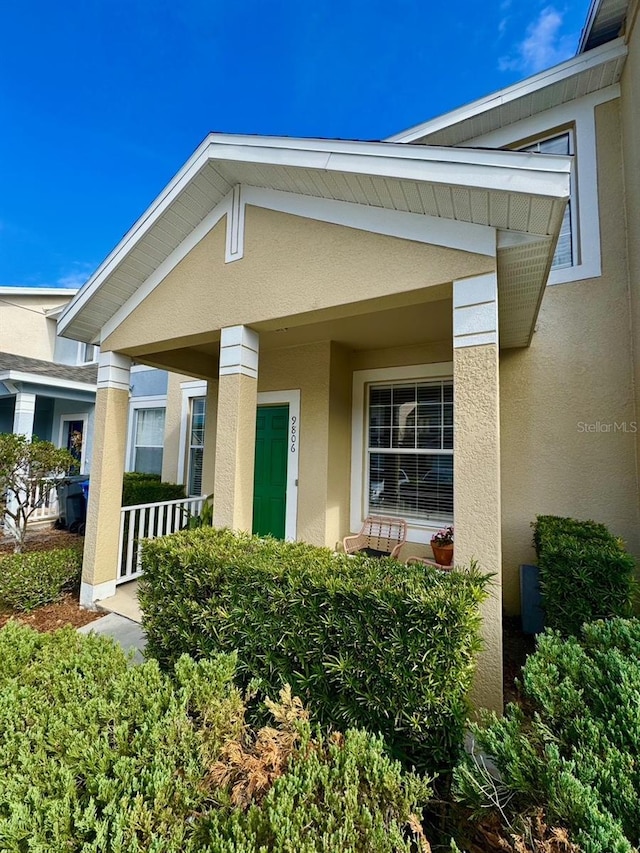 view of exterior entry featuring a porch