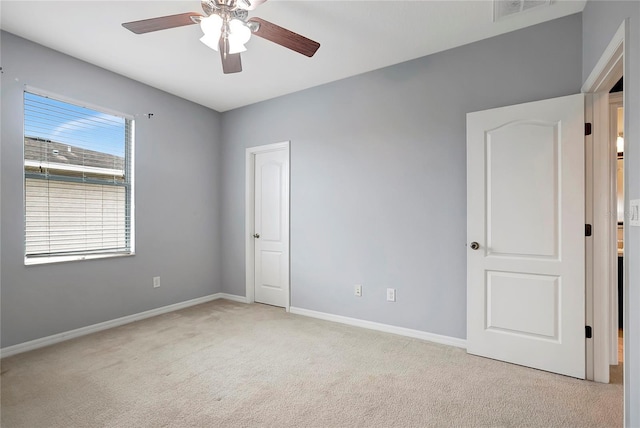 carpeted spare room with ceiling fan