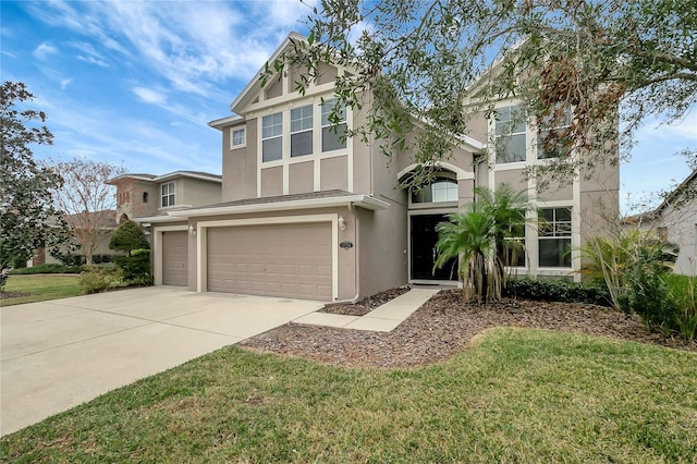 view of front of home featuring a front lawn and a garage