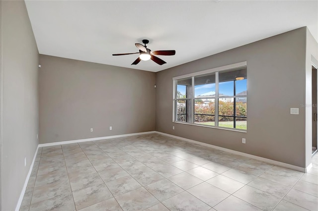 empty room with ceiling fan and light tile patterned flooring