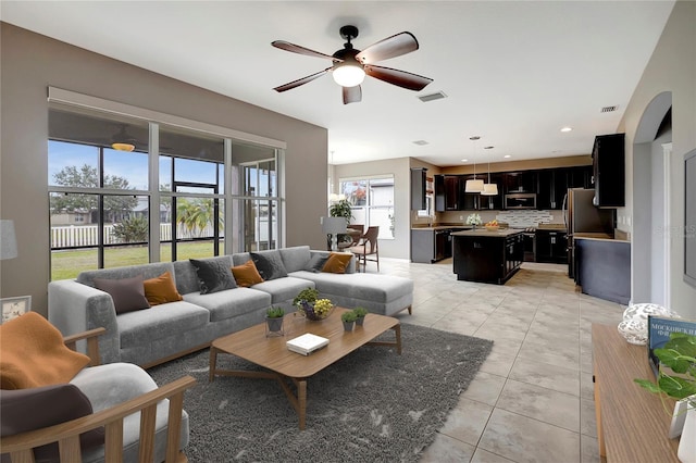 living room featuring ceiling fan and light tile patterned flooring