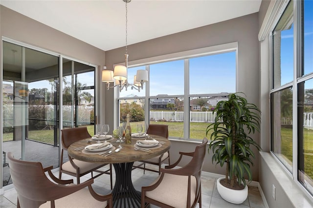 sunroom featuring a notable chandelier