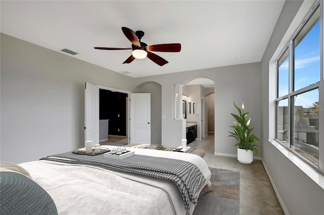 bedroom featuring ceiling fan and connected bathroom