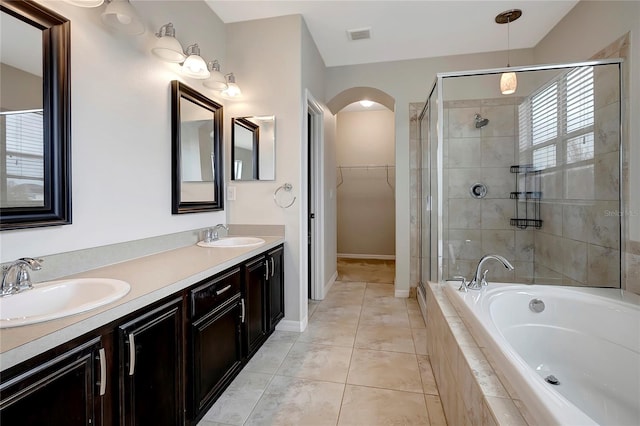 bathroom with plus walk in shower, tile patterned floors, and vanity