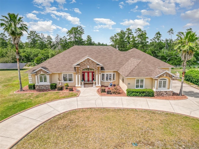 view of front of house with a front yard and french doors