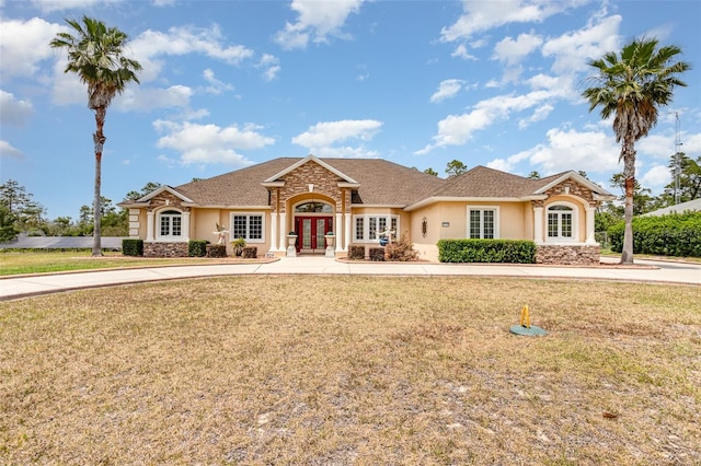 ranch-style house with a front yard and french doors