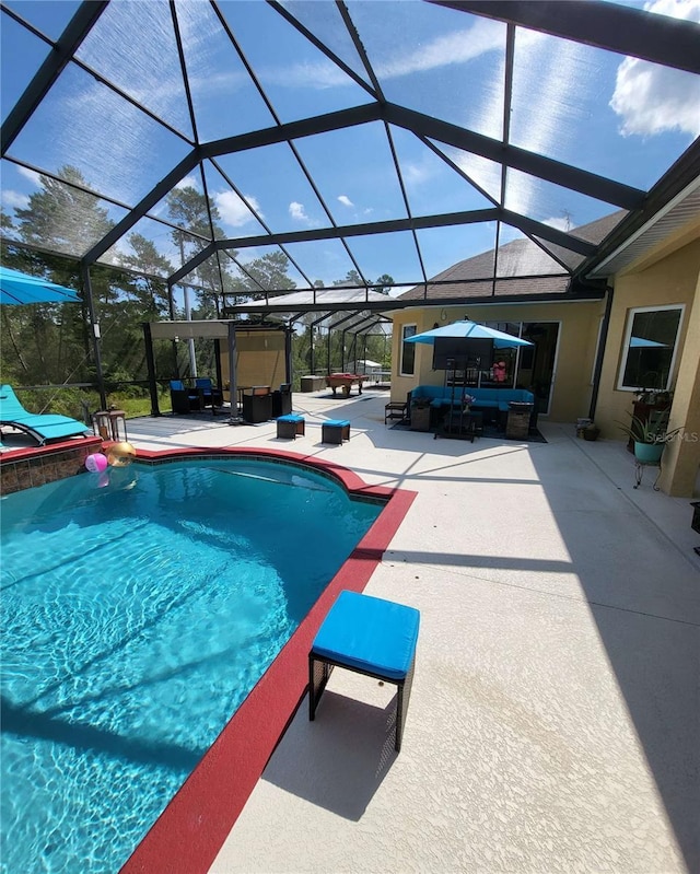 view of swimming pool with an outdoor living space, glass enclosure, and a patio