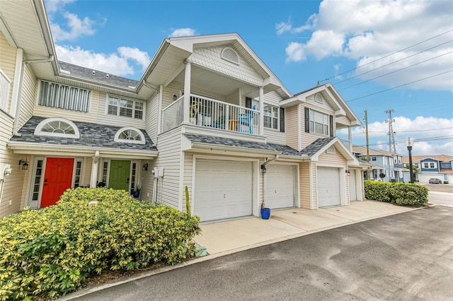 view of front of home with a balcony and a garage