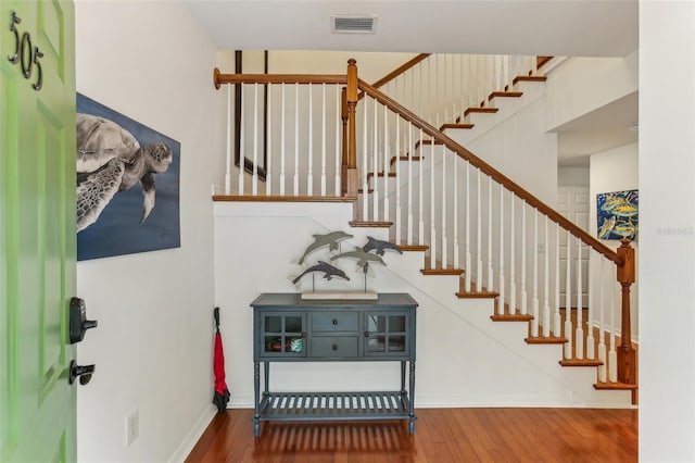 stairway with hardwood / wood-style flooring