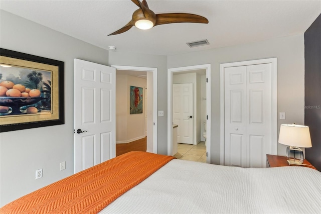 bedroom with a closet, ceiling fan, and light tile patterned floors