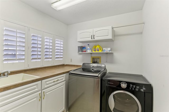 washroom featuring separate washer and dryer, cabinets, a healthy amount of sunlight, and sink