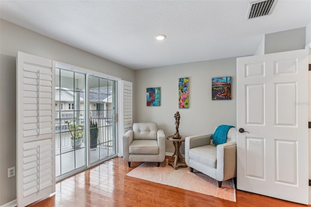 living area with hardwood / wood-style flooring