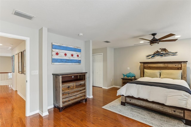 bedroom featuring ceiling fan, a closet, and dark hardwood / wood-style floors