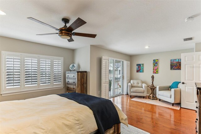 bedroom featuring access to outside, ceiling fan, and light hardwood / wood-style floors