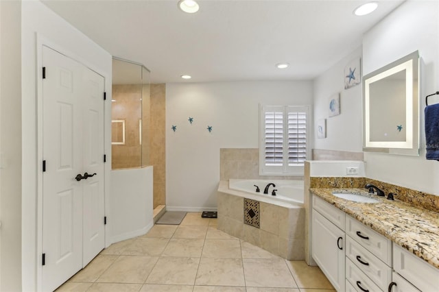 bathroom featuring independent shower and bath, tile patterned flooring, and vanity