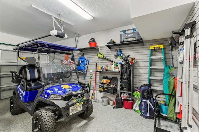 garage featuring wood walls and a garage door opener