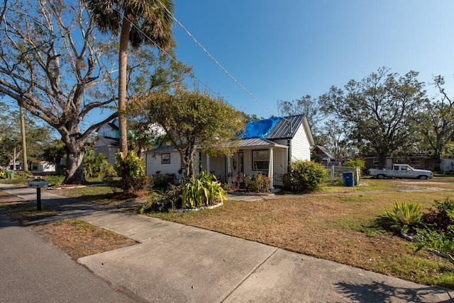 bungalow with covered porch and a front yard