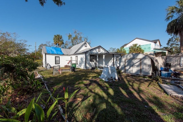 view of front of house featuring a front lawn and a storage unit