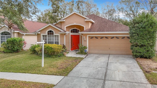 ranch-style home featuring a garage and a front lawn