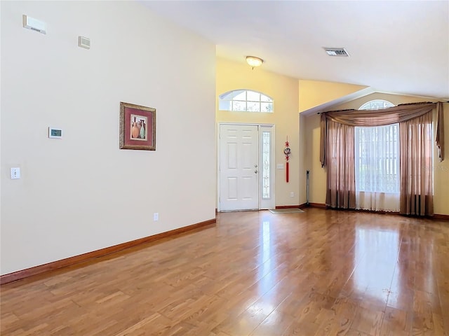 entryway featuring light hardwood / wood-style floors and lofted ceiling