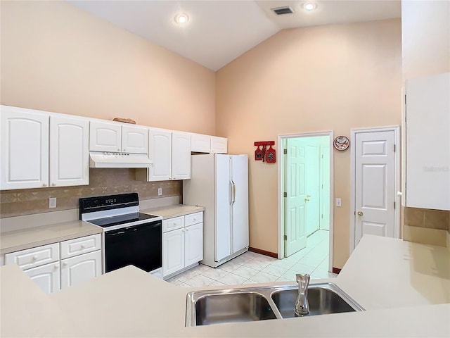 kitchen with white refrigerator, sink, white cabinets, vaulted ceiling, and electric range