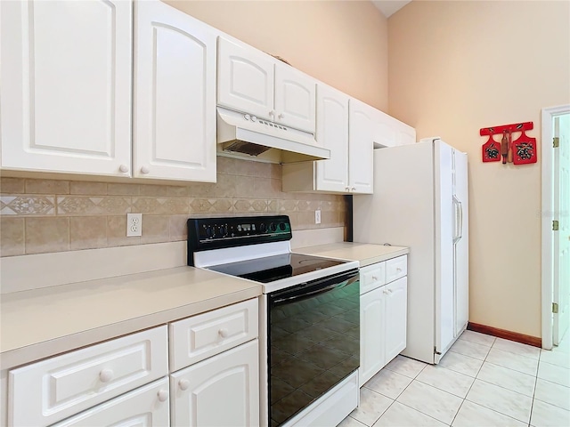 kitchen with white refrigerator, range with electric cooktop, white cabinetry, and light tile patterned floors