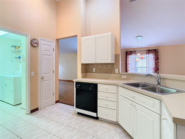 kitchen featuring washing machine and dryer, sink, black dishwasher, white cabinetry, and decorative light fixtures