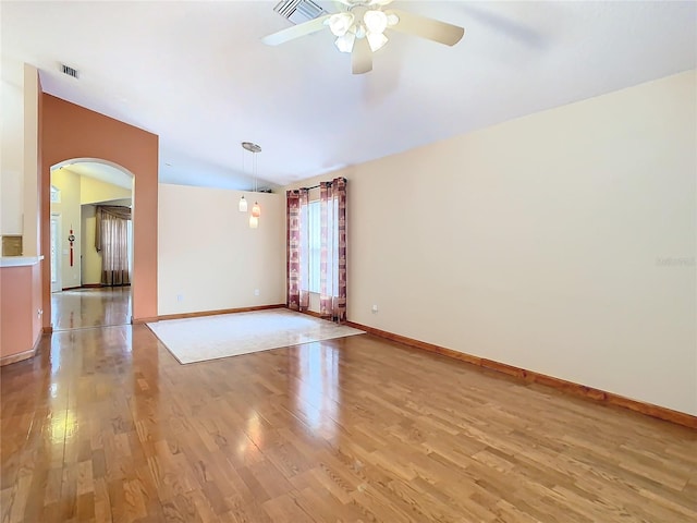 spare room with ceiling fan, light hardwood / wood-style flooring, and lofted ceiling