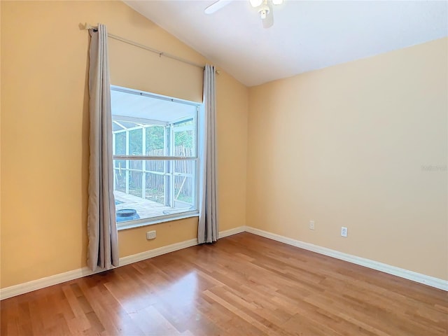 empty room featuring lofted ceiling, ceiling fan, and light hardwood / wood-style floors