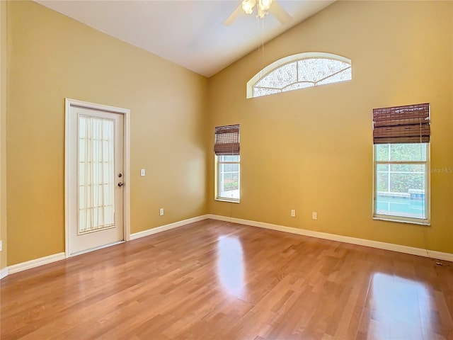 spare room featuring ceiling fan, light hardwood / wood-style flooring, and high vaulted ceiling